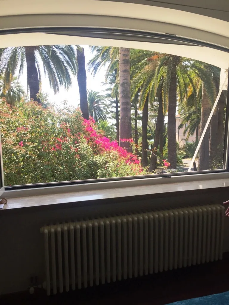 View of garden from bedroom in eight-room villa in Sanremo