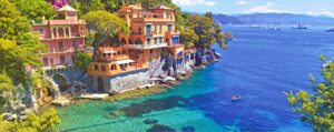 Colorful houses on a cliff by the sea in Liguria.