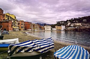 ligurian beach with covered boats on sand at morning. Italy