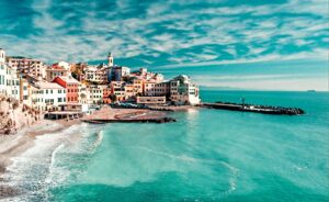 A panoramic view of the seafront promenade and the sandy beach of Sanremo, a popular tourist destination on the Italian Riviera.