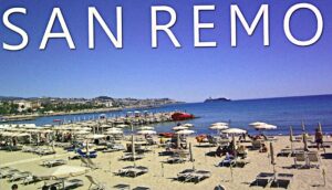 Sunny Sanremo beach with umbrellas on tha sand.